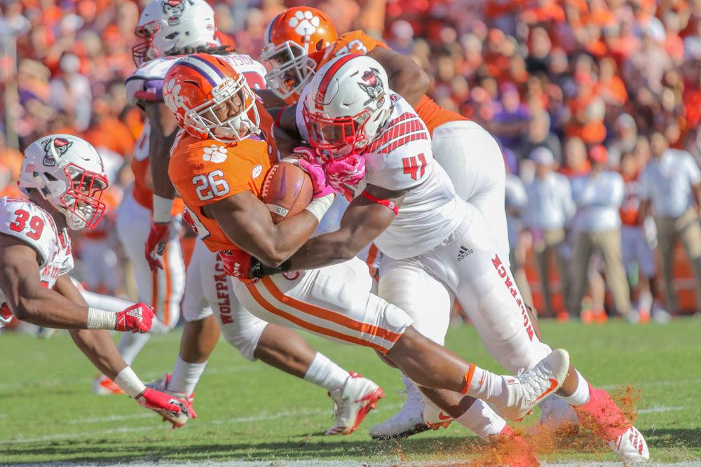 Redshirt freshman linebacker Isaiah Moore hits Clemson running back Adam Choice for a key stop&#160;on Saturday, Oct. 20 at Clemson Memorial Stadium. Moore had six solo tackles during the Wolfpack's 41-7 loss.