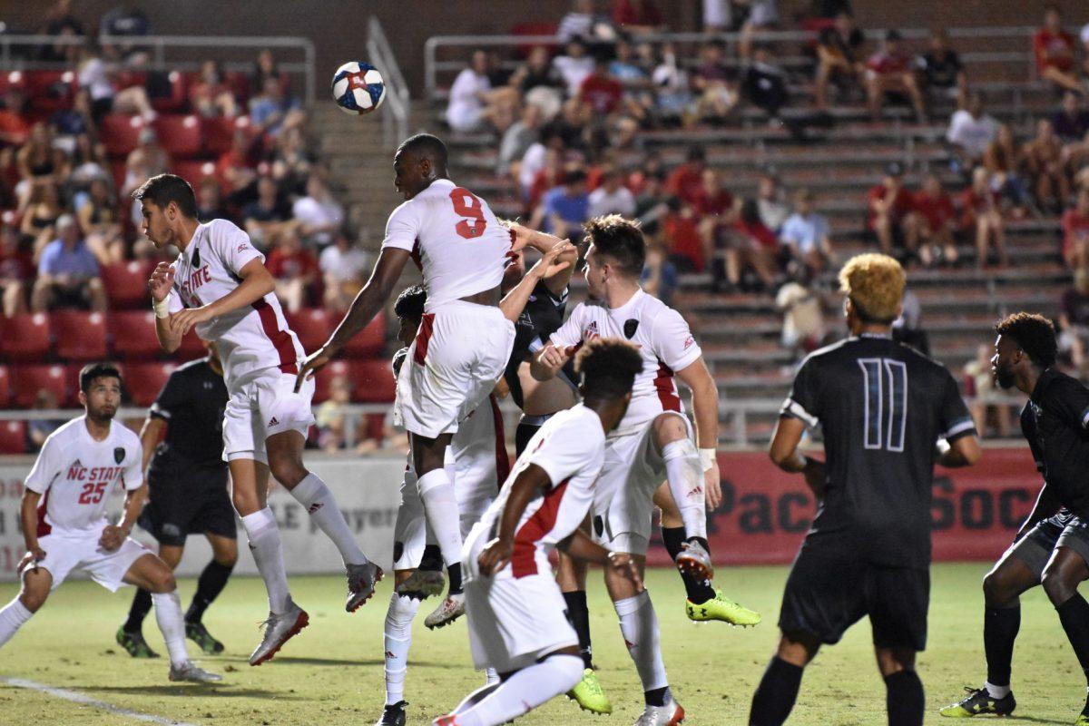 Sophomore forward Kuda Muskwe heads the ball during the game versus Loyola on Friday, August 30, 2019 in Dail Soccer Park. Muskwe scored one goal against the Greyhounds. NC State beat Loyola 2-1.