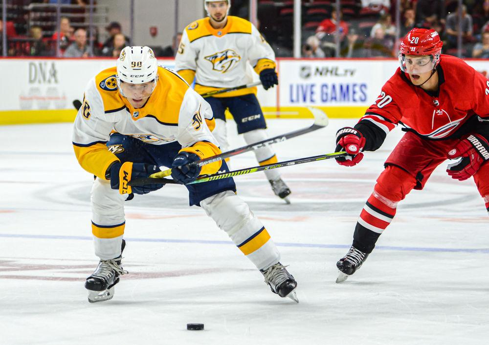 Hurricanes center Sebastian Aho reaches against Nashville Predators center Anthony Richard on Friday, Sept. 27 at PNC Arena. Richard scored one goal as the Predators beat the Hurricanes 2-1.