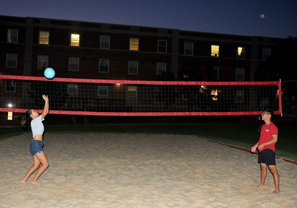 Second year agriculture and life science major Emily Fong and second year engineering major Chris Bui play volleyball at Tucker Beach on Monday, Sept. 16, 2019.