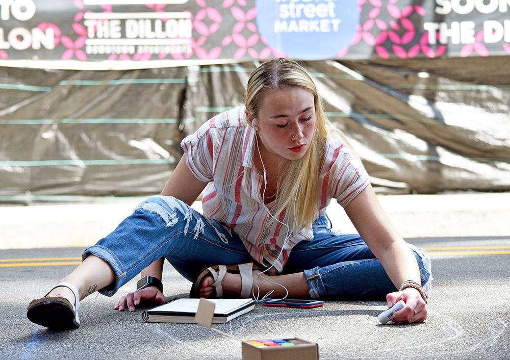 Local artist Tori McKay begins sketching her chalk design in the streets of downtown Raleigh at SPARKcon on Spet. 14, 2019. SPARKcon is an annual event that aims to showcase the talents of the creative community.
