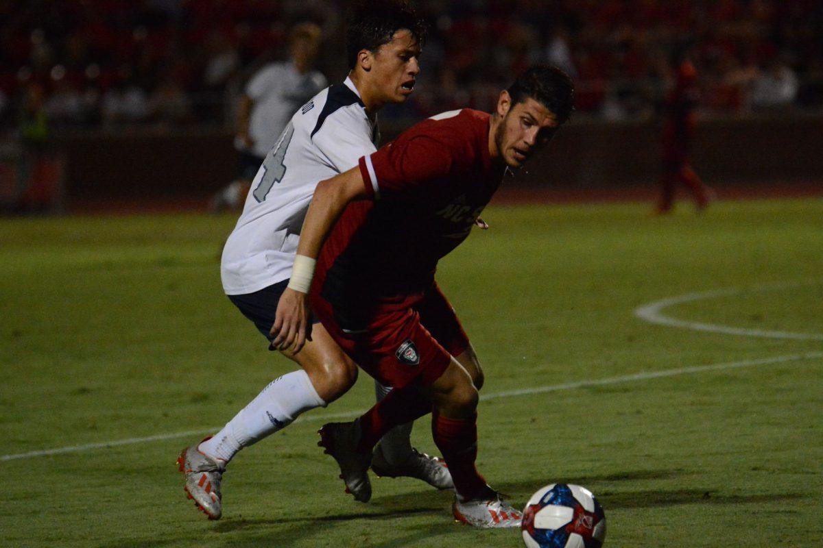 NC State men's soccer defense player Pablo Pedregosa wrestles for control against Longwood player at Dail Soccer Field on Friday September 6. The Wolfpack won 1-0.