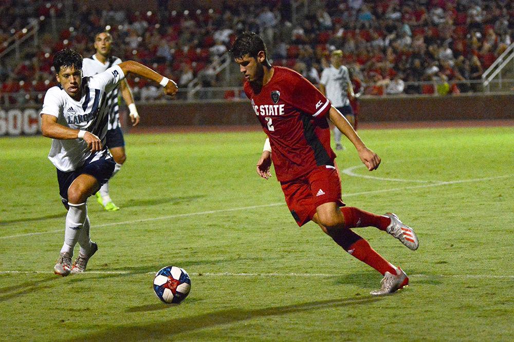 Freshman defenseman Pablo Pedregosa dribbles the ball against Longwood on Friday, Sept. 6, 2019 at Dail Soccer Field. The Wolfpack won 1-0.