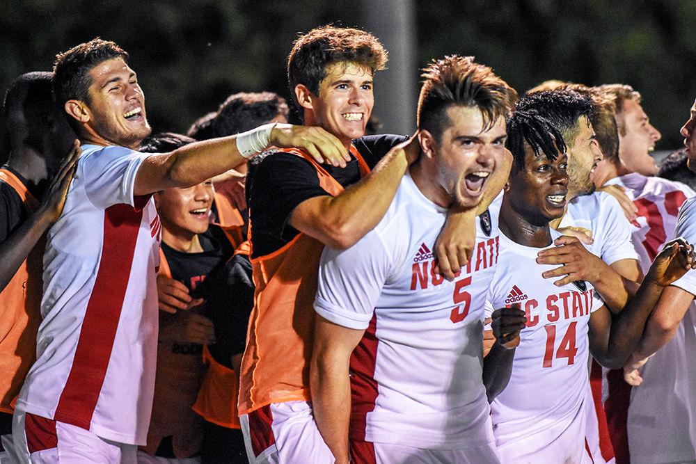 The NC State men's soccer team celebrates after junior defender Jamie Smith scored a goal against the Loyola Greyhounds on Friday, August 30, 2019 in Dail Soccer Stadium. This is Smith's first season with the Wolfpack after transferring from Limestone College. NC State beat Loyola 2-1.