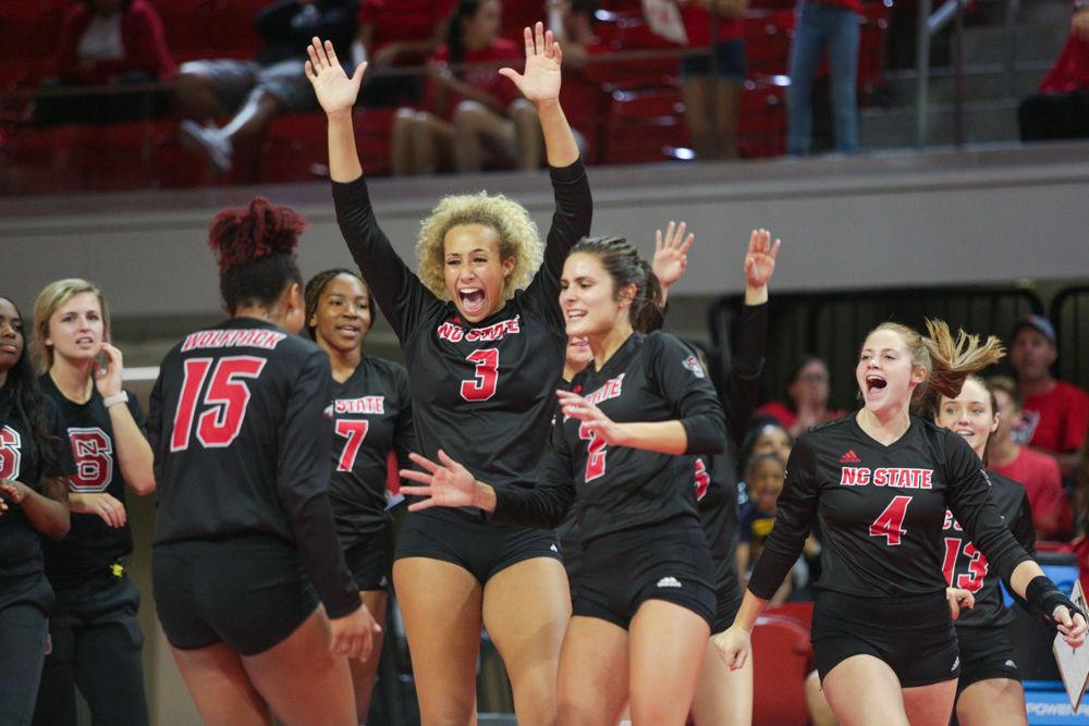 Sophomore outside hitter Jade Parchment joins Junior opposite hitter Melissa Evans and the rest of the team in celebrating a point during the 3-1 victory over Kansas State on Friday, Aug. 30 in Reynolds Coliseum.