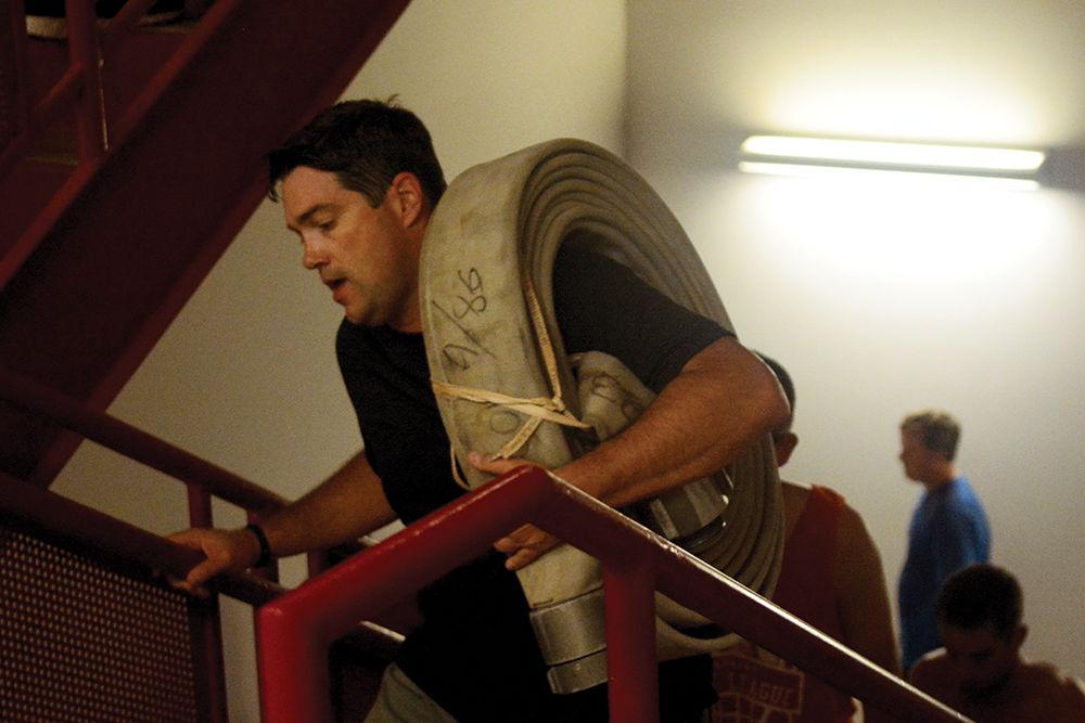 Adam Pfanmiler carries a hose up the stairs during the annual 9/11 Stair Climb in Carter-Finley stadium on Wednesday, Sept. 11, 2019. F3 members and local Raleigh residents climbed 110 flights in remembrance of the first responders who lost their lives in 2001.