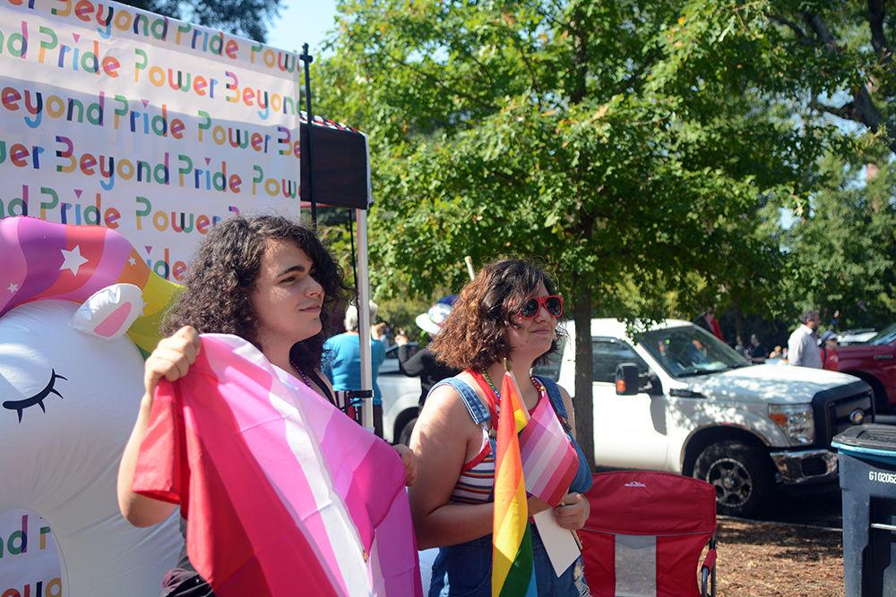 NC State students Maddy Arena and Reagan Santillan show off their flags at the Durham Pride Parade on Saturday, Sept. 28, 2019. State marched in the parade along with several other floats.