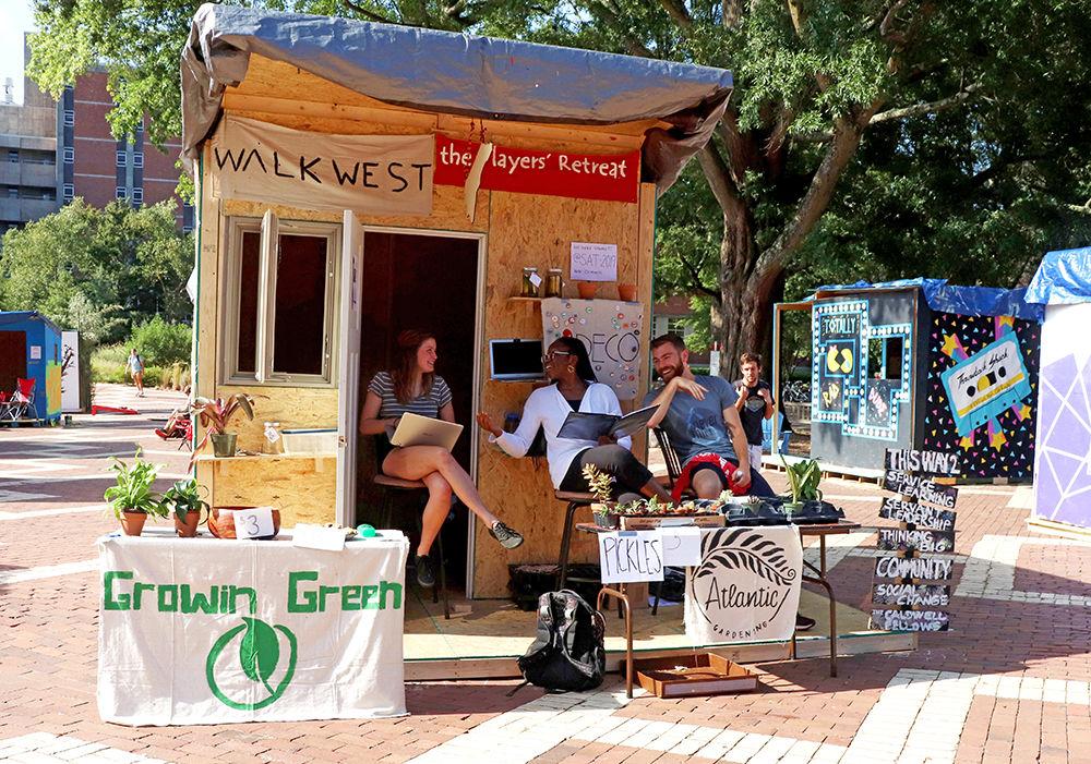Erica Lisowe a third-year biological engineering student with an ecological engineering concentration, Anu Frempong a third-year nutritional science student, and Jack O'Connor a third-year psychology student, are all members of the Caldwell Fellows Program participating in Shack-A-Thon on Sept. 25, 2019 in the Brickyard of NC State's campus. NC State's Shack-A-Thon has 45 student organizations come together to build 18 shacks to raise money for Habitat for Humanity in the Wake Community. "We have been involved with Shack-A-Thon for a long time," Lisowe said. "We really value being able to use the resources that we have to help the community, and Shack-A-Thon helps with that. It really aligns with our values. Learning becomes service living."
