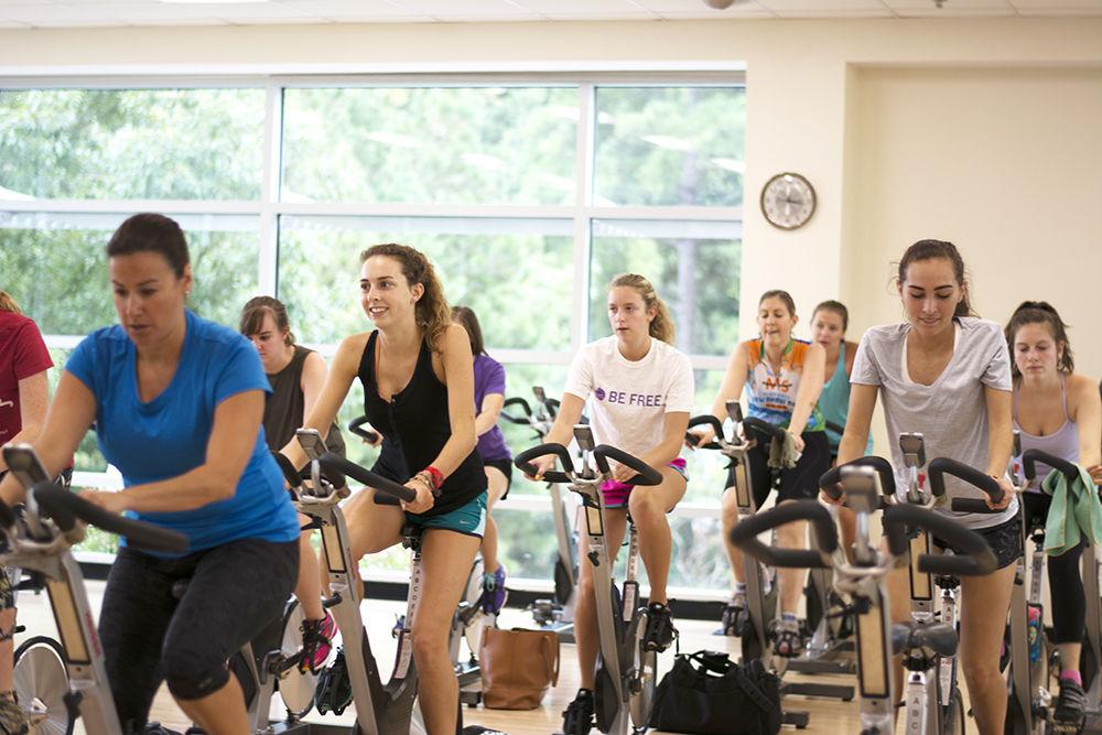 Students participate in a cycling class, one of the many classes offered by University Recreation. These classes are held every day of the week in Carmichael Recreation Center.