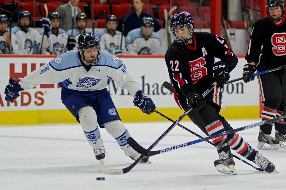 Ryan Kinney, a fourth-year studying mechanical engineering, skates past the UNC-Chapel Hill defense during the annual Backyard Brawl on Monday, Oct. 22, 2018 in PNC Arena. The Wolfpack beat the Tar Heels 9-5.