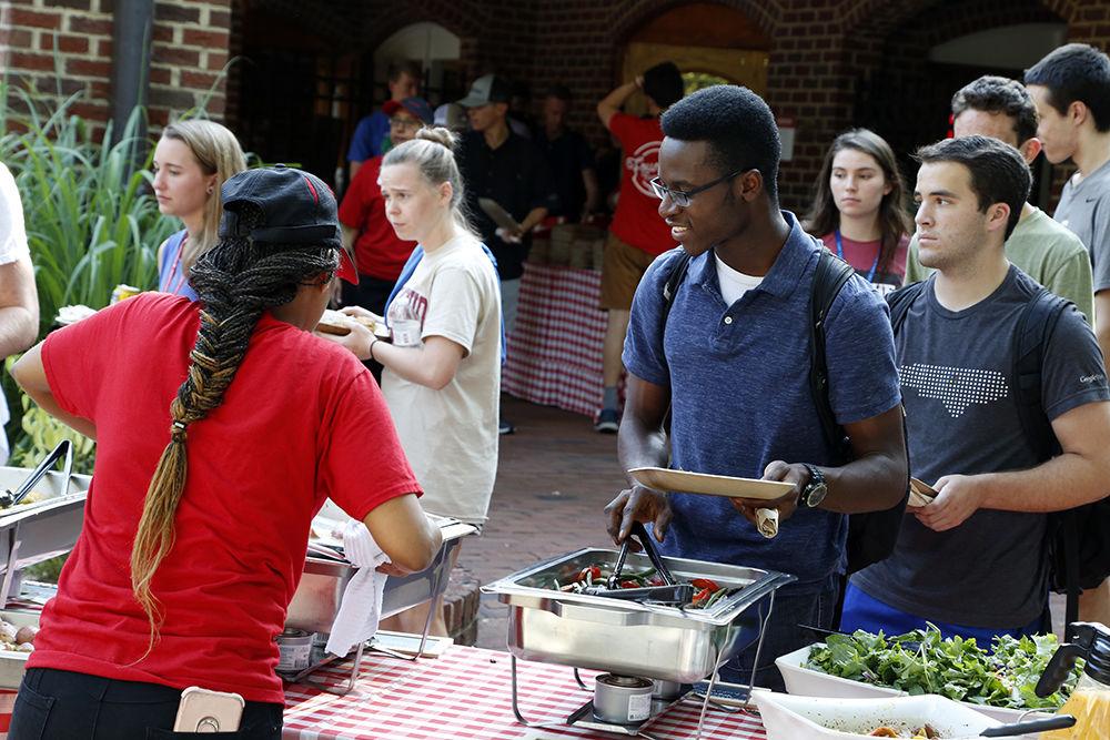 Emmanuel digs into a plate of veggies at the All American Meal on Tuesday, Sep. 10, 2019. The meal was held at Fountain and Clark Dining Halls.