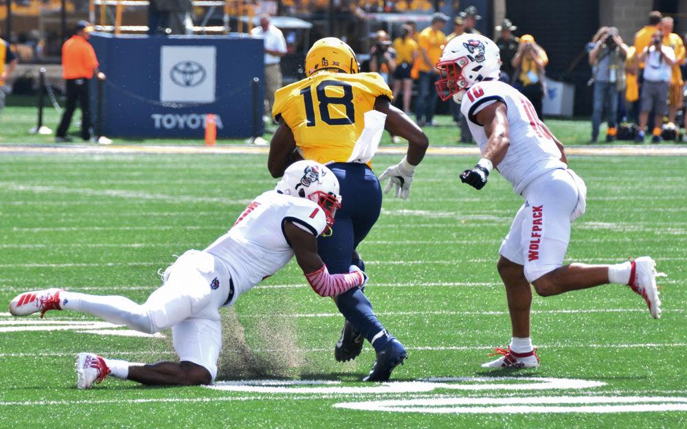 Junior cornerback Chris Ingram and sophomore safety Tanner Ingle tackle a Mountaineer receiver in their game against West Virginia on Saturday, Sept. 14, 2019 at Milan Puskar Stadium. The Wolfpack lost 44-27.