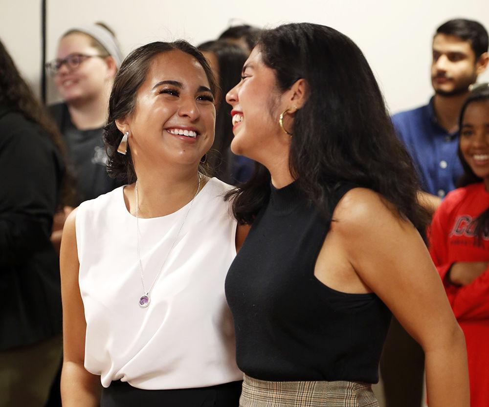 Daniela Patino-Zabaleta, a fourth year studying business administration and Adriana Ortiz, a third year studying business administration, share a smile at the Latinx Reveal Display on Tuesday Sep. 17, 2019. The reveal of the display was followed by a short reception in honor of all NC State Latinx community members.