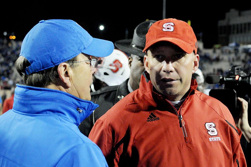 Head coach Dave Doeren&#160;talks to Duke's head coach David Cutcliffe after the end of the game Saturday, Nov. 9, 2013. The Wolfpack threw three interceptions and lost one fumble in their 38-20 loss&#160;to the Blue Devils at Wallace Wade Stadium.