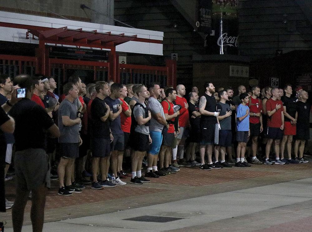 Participants of the annual 9/11 stair climb gather for the Star Spangled Banner at Carter-Finley Stadium on Sept. 11, 2019. They climbed 110 flights in rememberance of the First Responders who lost their lives in the World Trade Center in 2001.