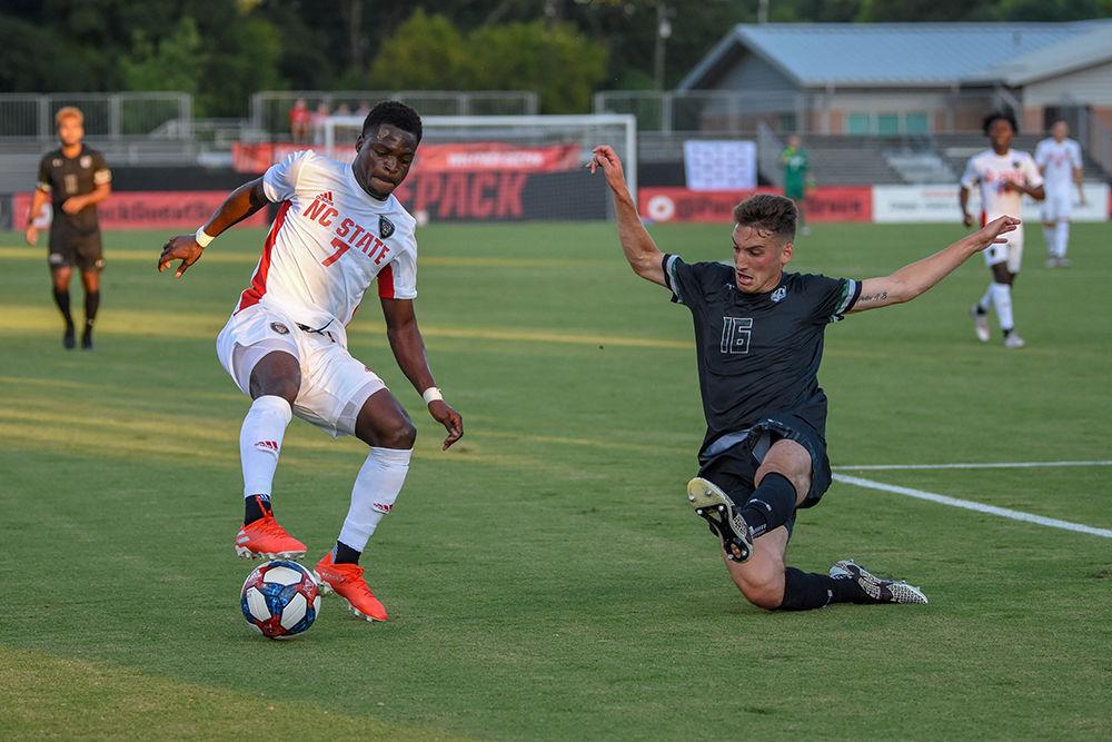 Sophmore forward Ivy Brisma cuts past a Loyola defender in the box on Friday, August 30, 2019 in Dail Soccer Park. NC State beat Loyola 2-1.