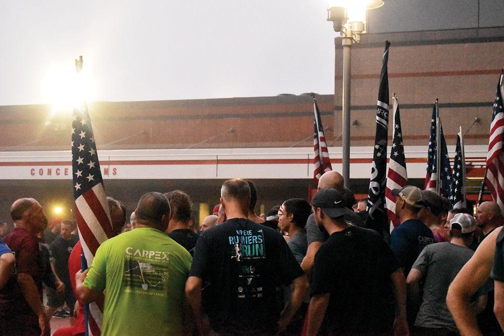F3 members hold the American flag after their annual 9/11 Stair Climb. In remembrance of 9/11, people from across Raleigh climbed 110 flights of stairs at Carter-Finley Stadium on Wednesday, Sept. 11, 2019.