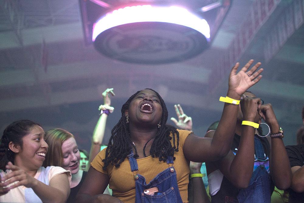 T'Erika Lee, a senior studying political science, and Kyla Talmadge, a senior studying criminology and Arabic, jam out to DJ Trellz's opening set with Sharon Jackson, a sophomore studying psychology, and the rest of the audience in Reynolds Coliseum, Thursday, Sept. 19, 2019. Dr Trellz opened for T-Pain as part of the packHOWL concert.