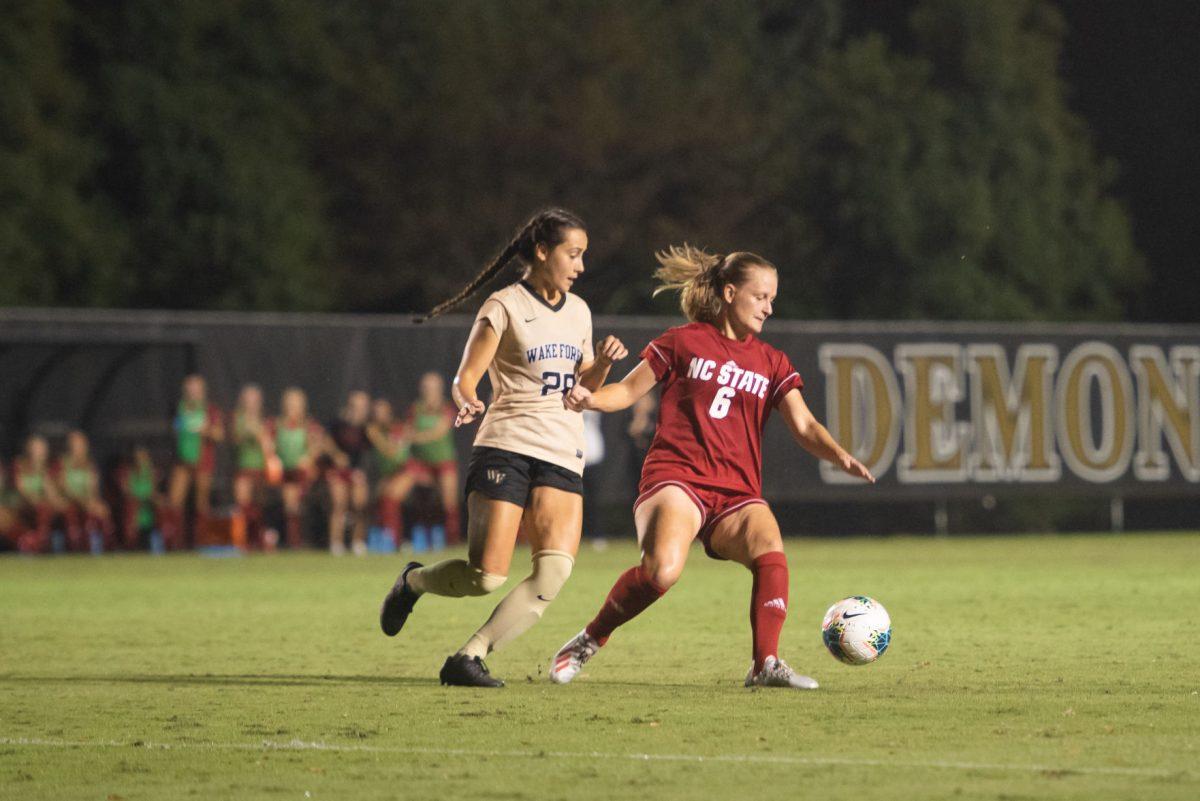 Redshirt sophomore defender Lulu Guttenberger attempting to shed an opponent during the match versus Wake Forest on Sunday September 29, 2019 at W. Dennie Spry Stadium. Wake Forest and NC State tied 1-1.