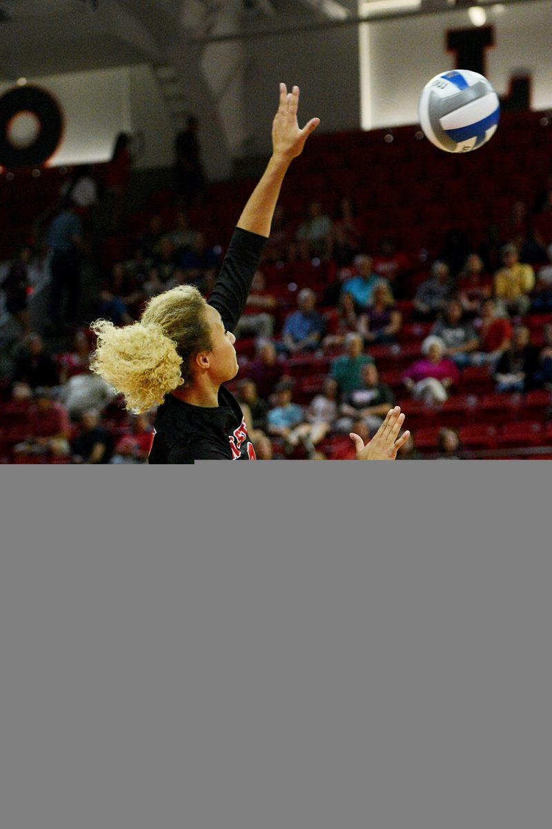 Junior opposite hitter Melissa Evans spikes the ball against Virginia Tech on October 4 in Reynolds Coliseum. Evans played in five sets and had 20 kills and one dig in the 3-2 win over Virginia Tech.