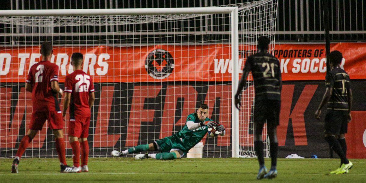 Redshirt senior keeper Vincent Durand saves the ball during the 3-1 loss to No. 6 Wake Forest on Friday, Oct. 11, 2019 in Dail Soccer Stadium.