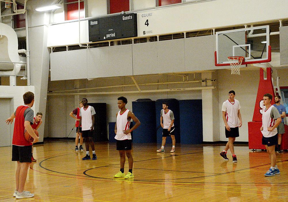The men's club basketball team listens to instructions during a practice in Carmichael Gym on Wednesday, Sept. 18, 2019.