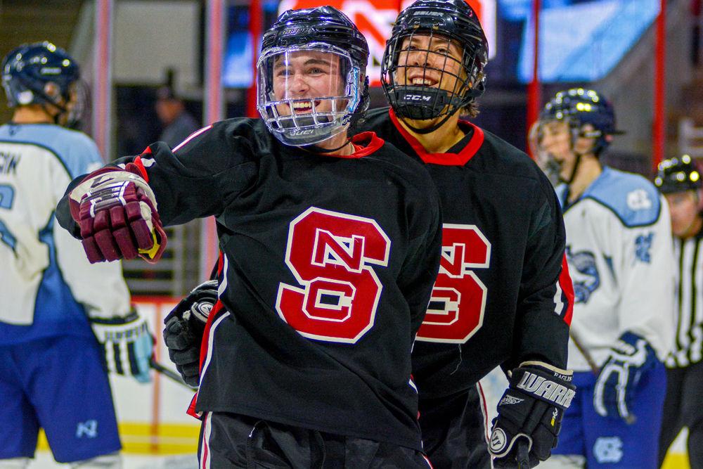 Riley Johnson, a first-year studying biology, and Alex Robinson, a first-year studying mechanical engineering, celebrate&#160;Johnson's goal to tie the game at 3-3 during the annual Backyard Brawl on Monday, Oct. 22 at PNC arena. The Icepack beat UNC-Chapel Hill 9-5.
