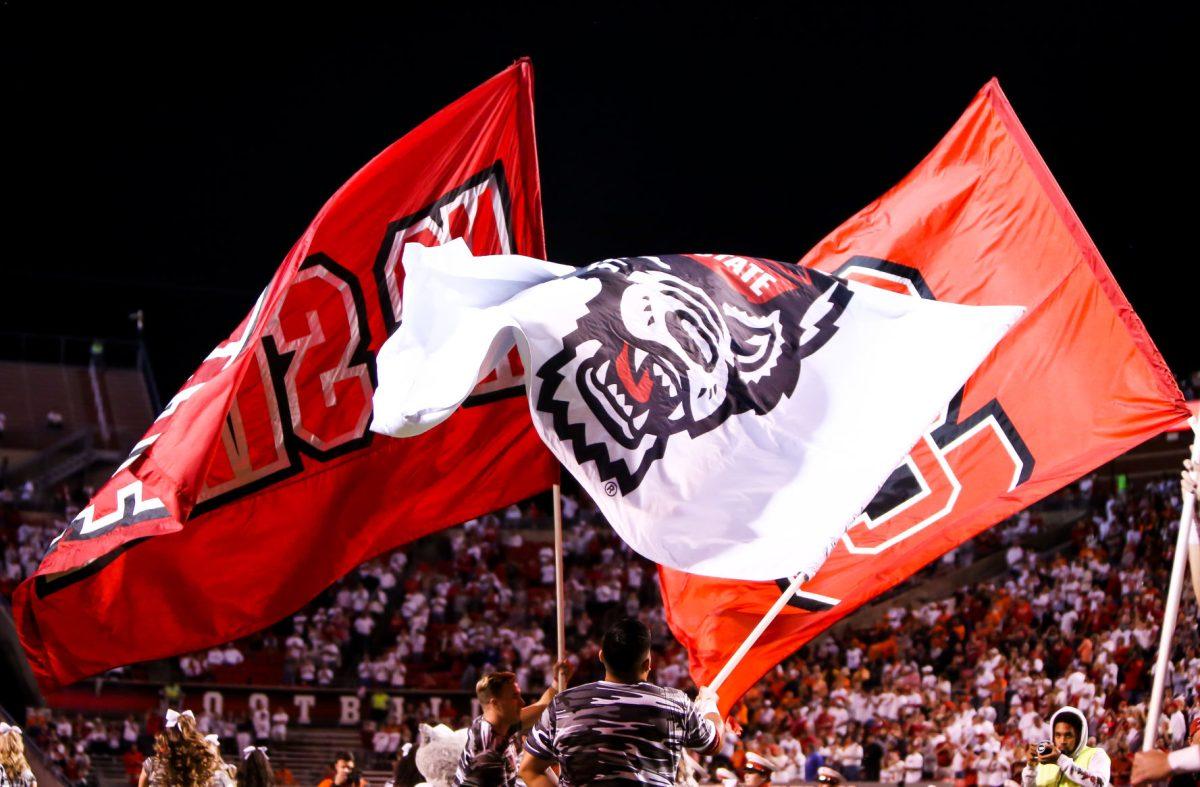 School flags fly before the introduction of the home team as the NC State hosted the Syracuse Orange on Thursday, October 10, 2019. NC State won the game 16-10.