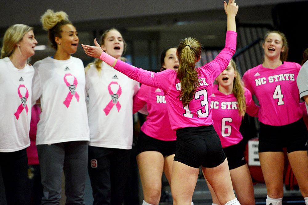 Freshman defensive specialist, Erin Kearney hypes up the team after the Wolfpack score a point in Reynolds Coliseum on October 27. Kearney played in one set in the Wolfpack&#8217;s 3-0 loss to Syracuse.