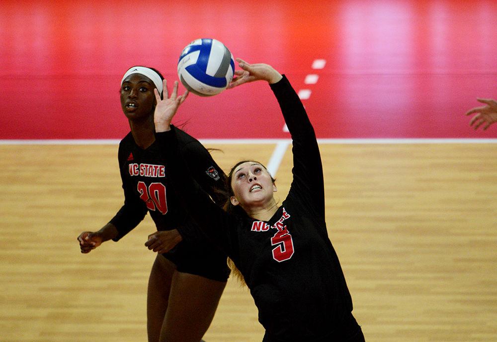 Freshman setter Kristen McDaniel sets the ball against Virginia Tech on October 4 in Reynolds Coliseum. McDaniel played in four sets with 19 assists and eight digs in the 3-2 win over Virginia Tech.