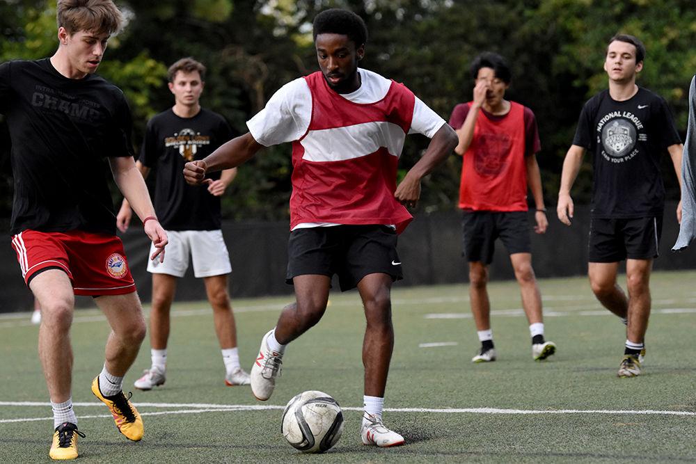 Third year Derek Walker, a player for club men's soccer, dribbles the ball during practice on Monday, Oct. 7, 2019 in Miller Field.