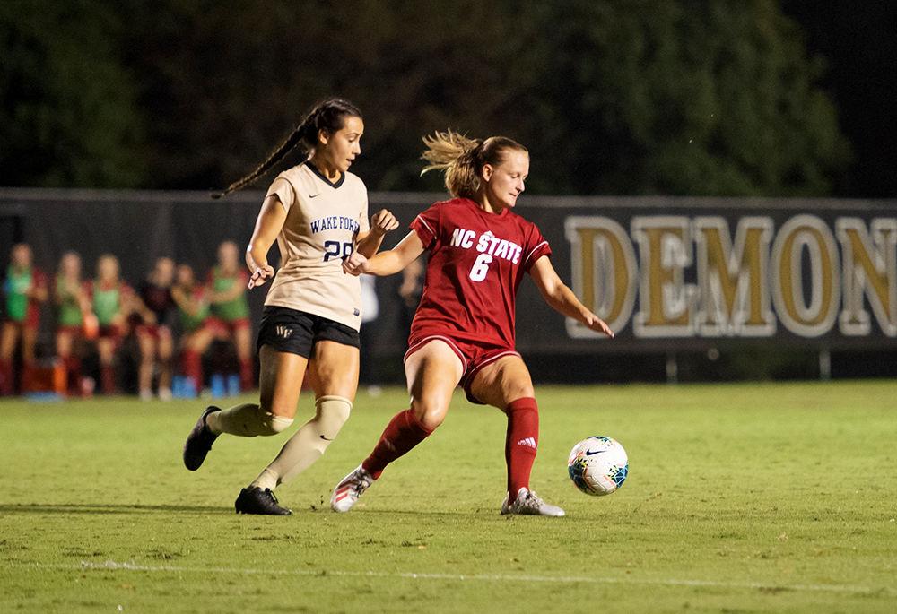 Redshirt sophomore defender Lulu Guttenberger attempting to shed an opponent during the match versus Wake Forest on Sunday, Sept. 29, 2019 at W. Dennie Spry Stadium. Wake Forest and NC State tied 1-1.