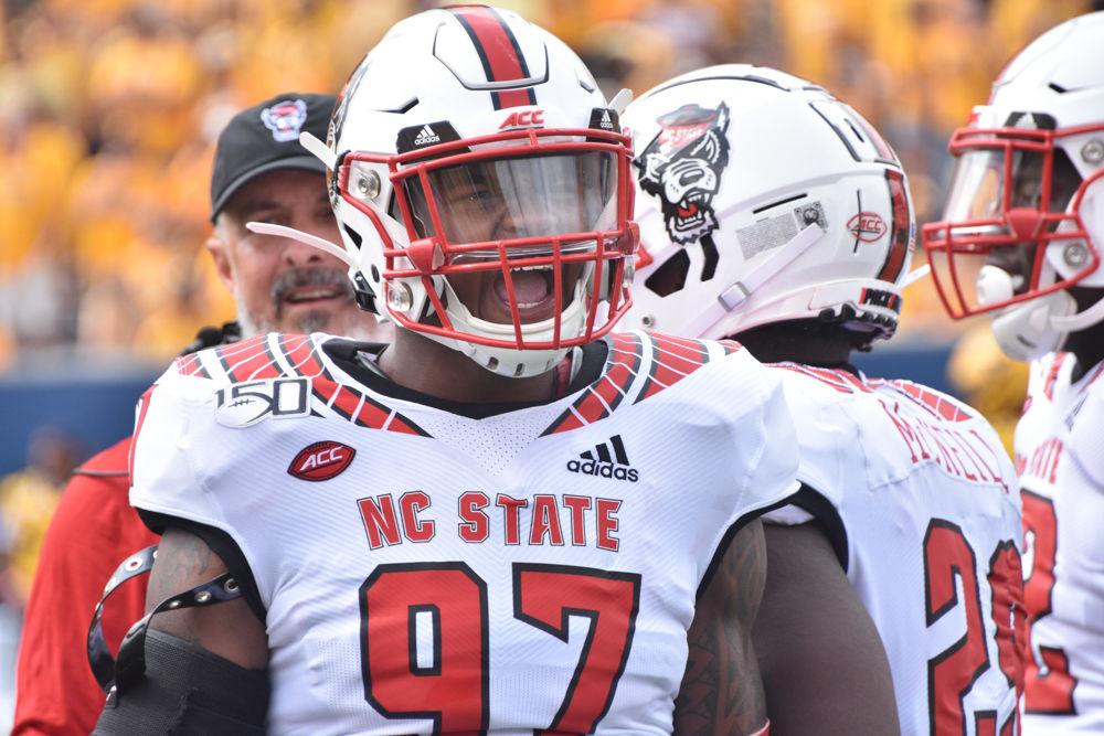 NC State redshirt sophomore defensive end Xavier Lyas gets his teammates hyped before the team's game against West Virginia on September 14, 2019 at Milan Puskar Stadium. The Wolfpack lost, 44-27.