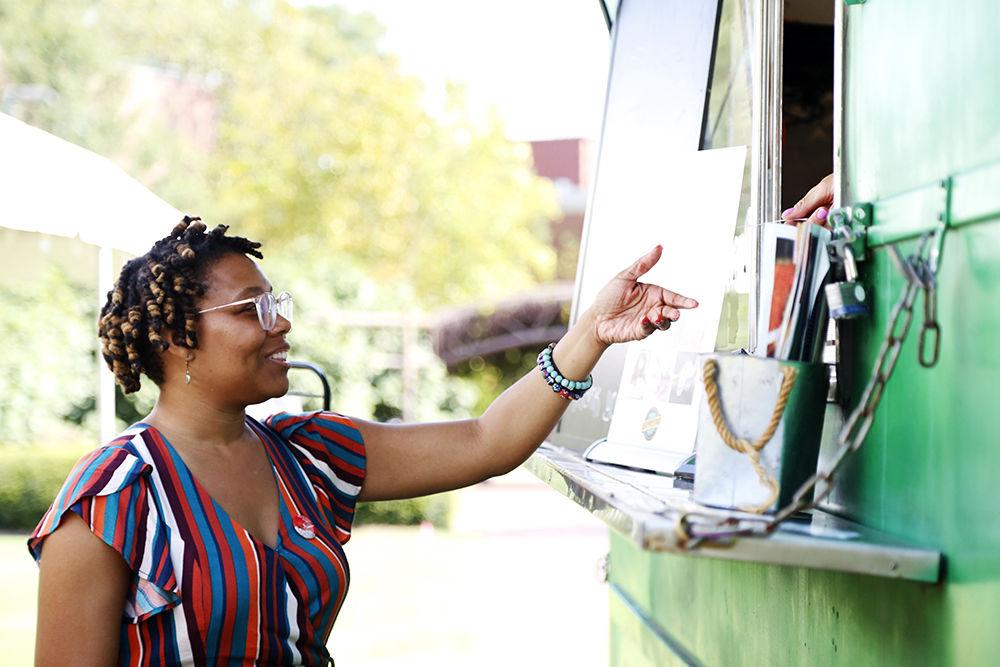 Poole Academic Adviser DeWhitney Upchurch gets ready to sample chicken empanadas at the Latinx Barrio Party held at General Scott Courtyard on Tuesday, Oct. 1, 2019. Qspresso, a Cuban and Latino Fusion food truck was featured at the event offering free samples from their menu.