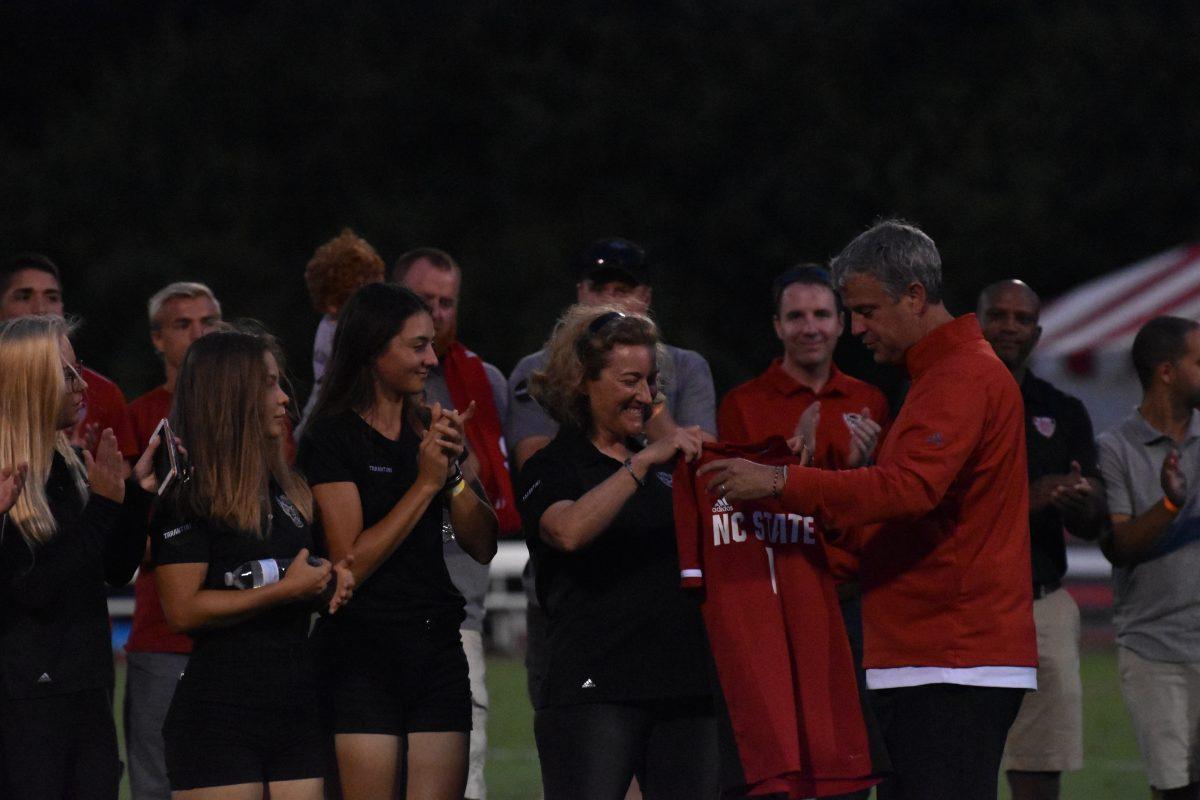 Page Marsh, the wife of former NC State men's soccer coach George Tarantini, accepts a commemorative jersey in his honor during the NC State men's soccer game vs Notre Dame on Friday, Oct. 4, 2019 at Dail Soccer Stadium. George Tarantini died Wednesday, September 25, 2019 and was the winningest soccer coach in NC State history.