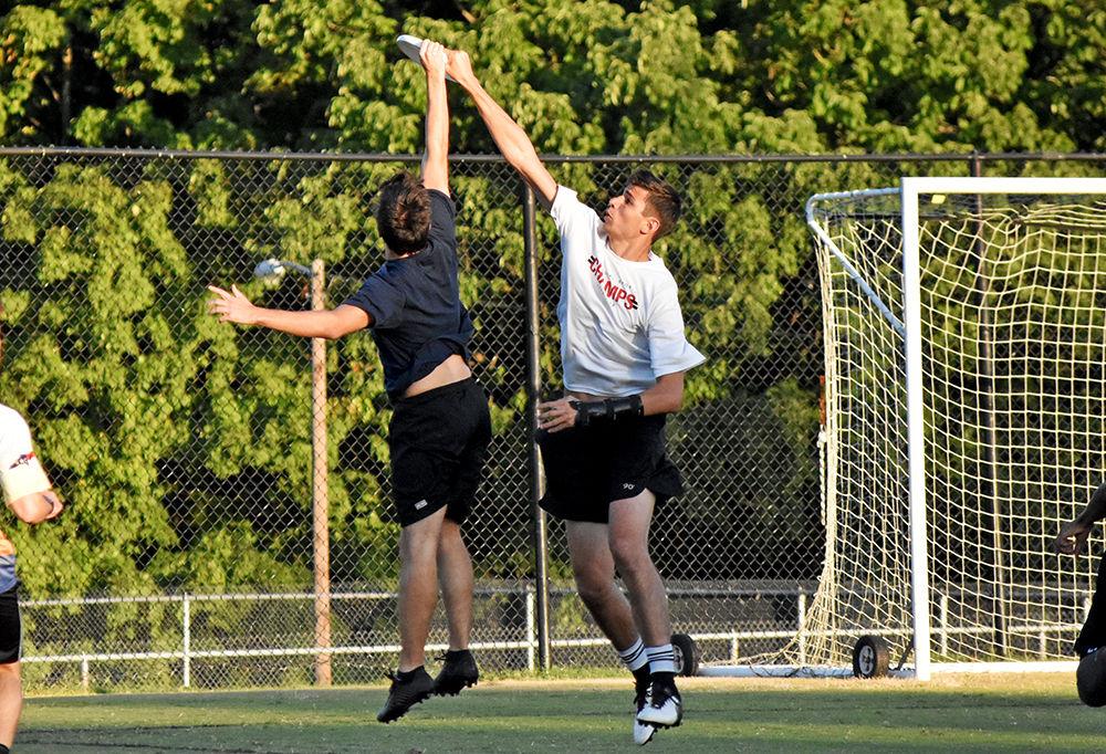 Third years Matt Tucker and Eric Feign both jump up to grab the disc out of the air at the endzone. Men&#8217;s Ultimate Frisbee scrimmages against other teammates to practice backhand leading tosses and effective defense at Method Fields on Tuesday, September 24, 2019.