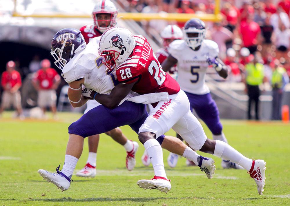 Senior cornerback Kishawn Miller tackles a WCU player on Saturday, Sept. 7, 2019 at Carter-Finley Stadium. The Wolfpack won 41-0.