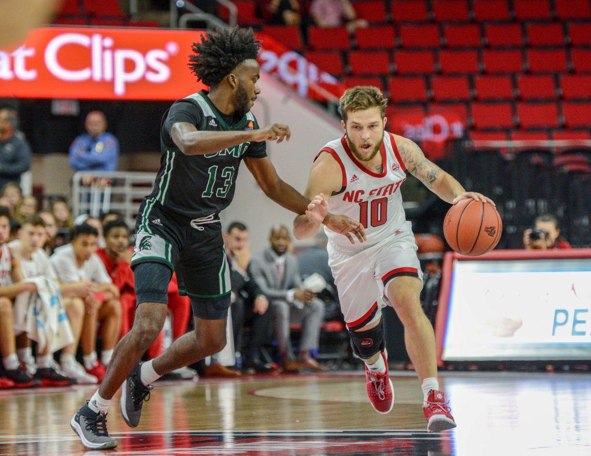 Junior guard Braxton Beverly dribbles down the court during the game versus Mount Olive on Sunday, Oct. 27, 2019 in PNC Arena. NC State beat Mount Olive 113-73.