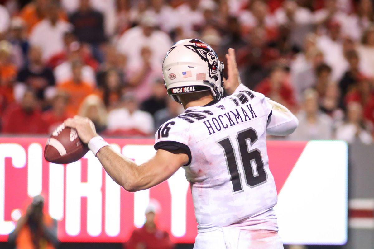 NC State redshirt sophomore quarterback Bailey Hockman throws a pass. NC State hosted the Syracuse Orange on Thursday, October 10, 2019. NC State won the game 16-10. Hockman, who had the 'N' on his jersey sewn on backwards, threw for 205 yards in the win.