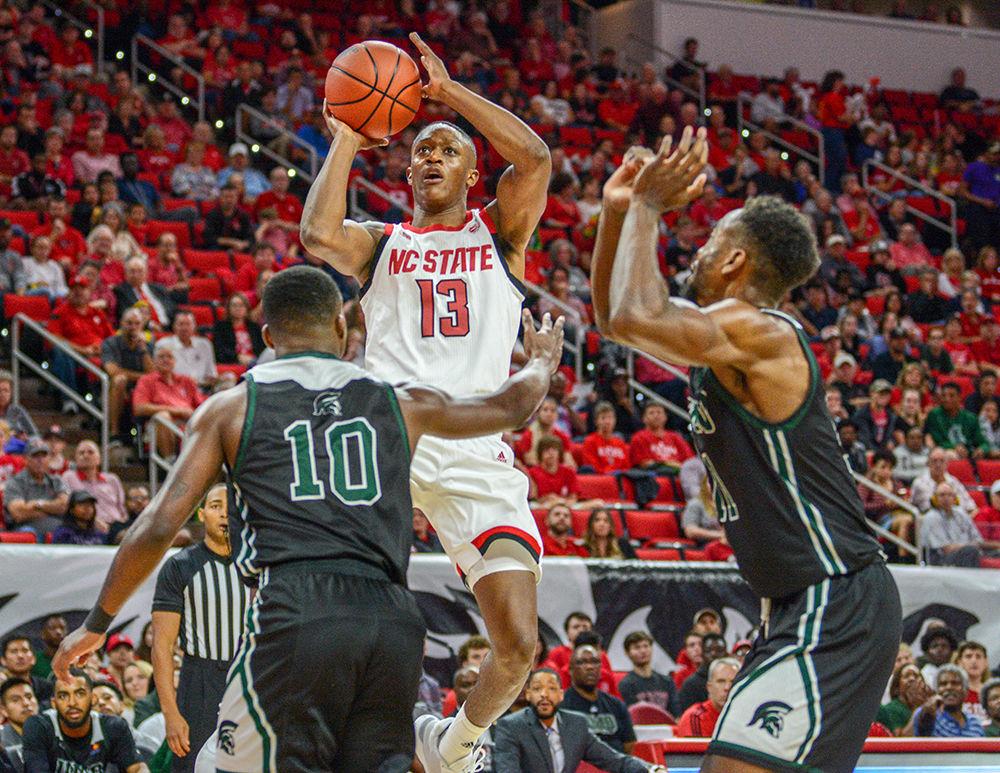 Redshirt senior guard CJ Bryce goes up for a quick shot over two Mount Olive defenders on Sunday, Oct. 27, 2019 in PNC Arena. Bryce had a double-double against the Trojans, scoring 20 points and having 10 rebounds. NC State beat Mount Olive 113-73.