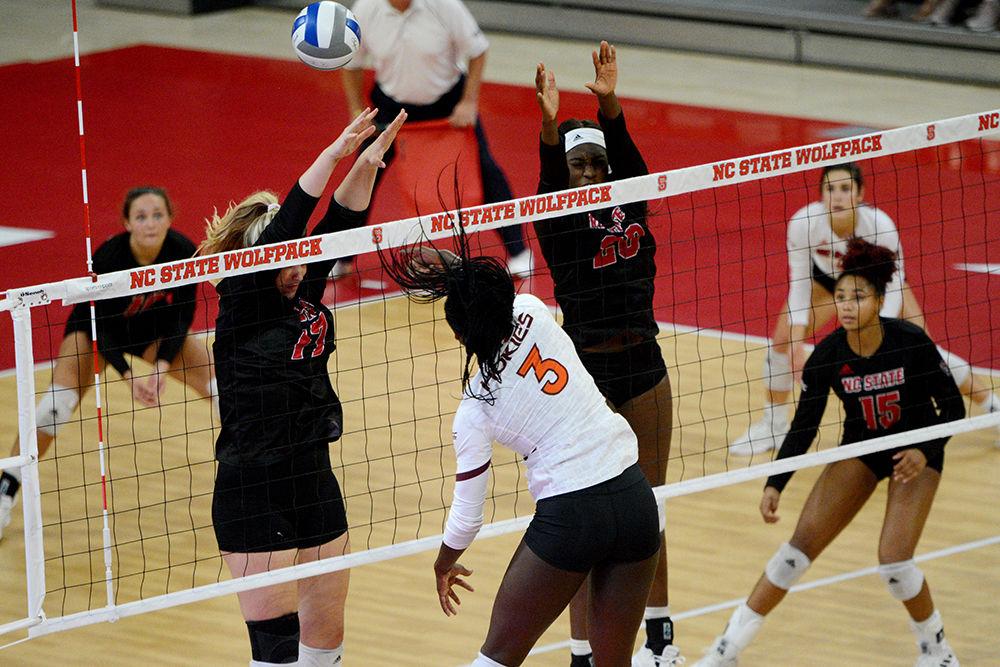 Redshirt junior middle blocker and right side Jessica Kemp and senior middle blocker Lauryn Terry attempt to block a hit against Virginia Tech on October 4 in Reynolds Coliseum. Kemp played in five sets with 22 kills, five blocks and one dig. Terry played in four sets with three kills, one ace and five blocks in the 3-2 win against Virginia Tech.