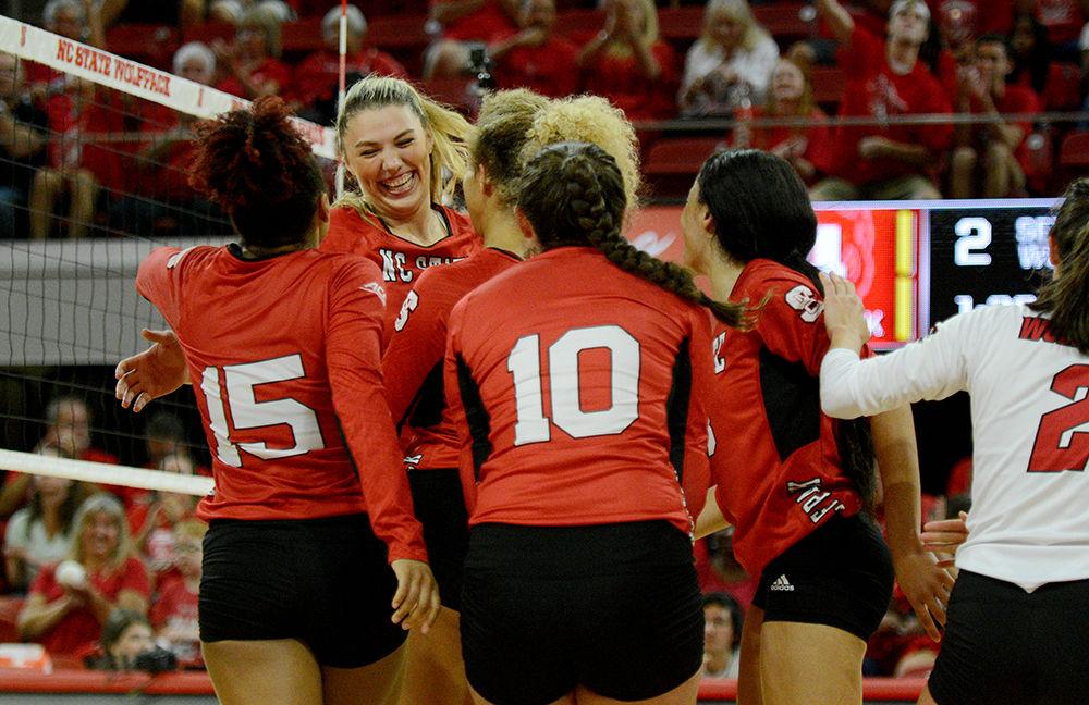 Teammates surround redshirt junior middle blocker and right side, Jessica Kemp after she kills the ball against UNC on Oct. 2, 2019 in Reynolds Coliseum. Kemp played in five sets and had 14 kills and one block in the 2-3 loss to UNC.