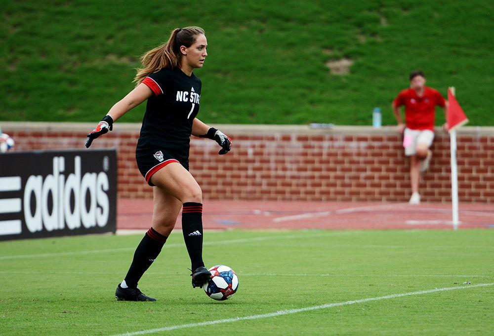Junior goalkeeper Jessica Berlin secures the ball before putting it back into play against Furman at the Dail Soccer Field on Sunday, Sept. 15, 2019. The Wolfpack beat the Paladins 3-1.