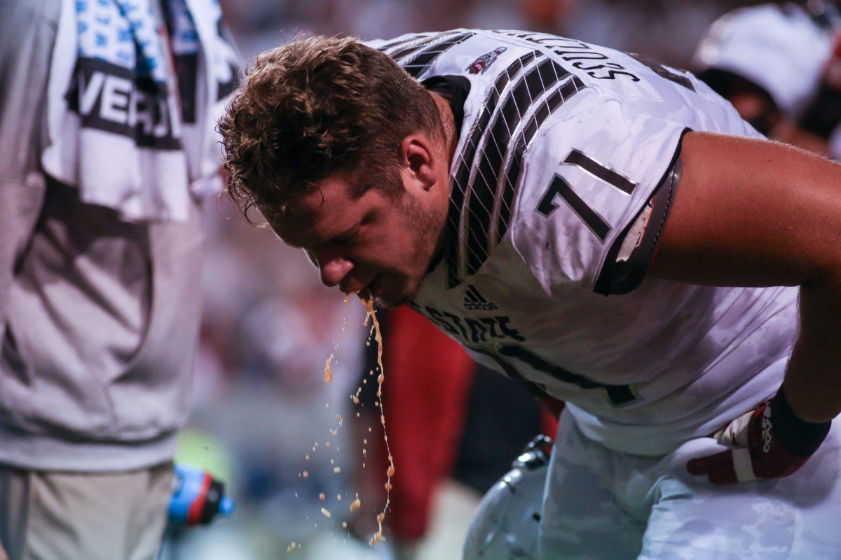 Redshirt junior offensive guard Joe Sculthorpe pukes during a timeout before NC State's second possession. NC State hosted the Syracuse Orange on Thursday, October 10, 2019. NC State won the game 16-10.