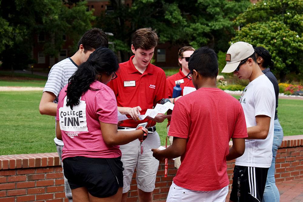 Peer mentor, Mitchell Moravec, helps Summer START participants navigate through campus using an NC State campus map. Moravec was one of the many peer mentors who gave a tour to students during the Wolfpack Wondering event on Sunday, June 25. The event allowed students to see the buildings that there classes were going to be held in during summer session II.