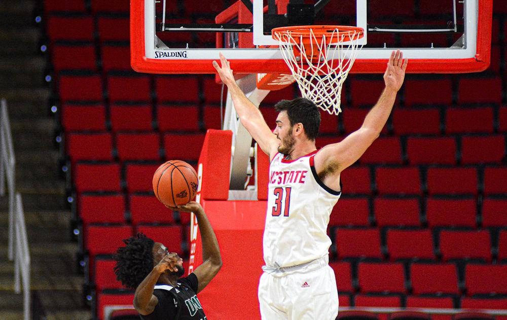 Graduate forward Pat Andree contests a shot by Mount Olive on Sunday, Oct. 27, 2019 at PNC Arena. Andree recorded 17 points and four rebounds as the Wolfpack won 113-73.