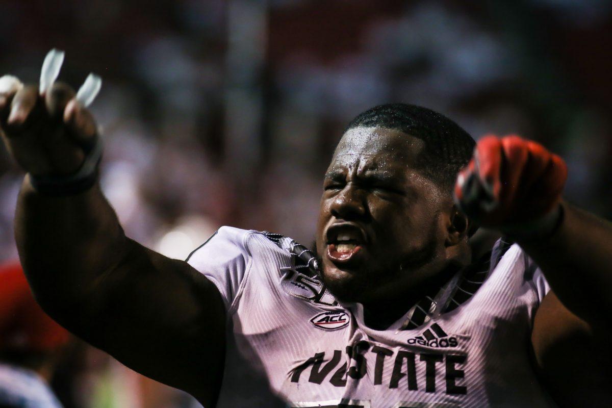 NC State redshirt sophomore center Grant Gibson implores the crowd to make noise on a late defensive stand. NC State hosted the Syracuse Orange on Thursday, October 10, 2019. NC State won the game 16-10.