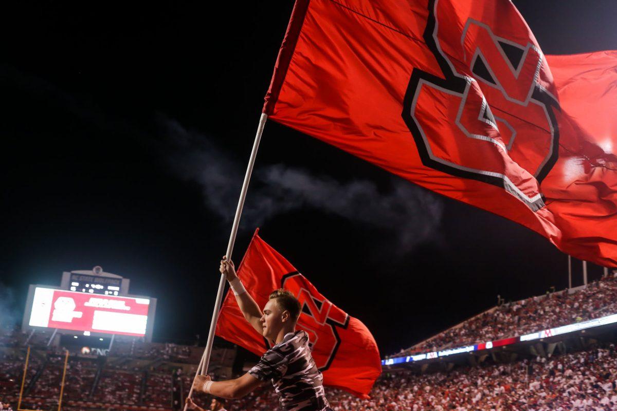 School flags fly following an NC State score as the NC State hosted the Syracuse Orange on Thursday, October 10, 2019. NC State won the game 16-10.