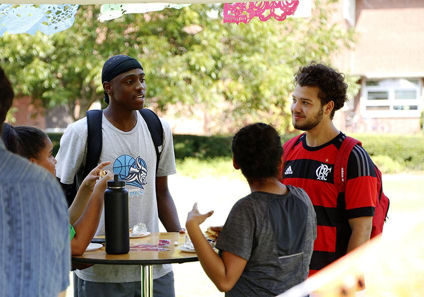 Mateus Ibarguen, a second year economics major, Amy Sauceda, a second year social work major, Kimmie Crow, a second year animal science major, and Joel Sturdivant, a first year business administration major, have lunch at the Latinx Barrio Party held at General Scott Courtyard on Tuesday, Oct. 1, 2019. This years Barrio Party invited students and staff to celebrate Latin heritage month with the Diversity and Inclusion team based in Poole College of Management.