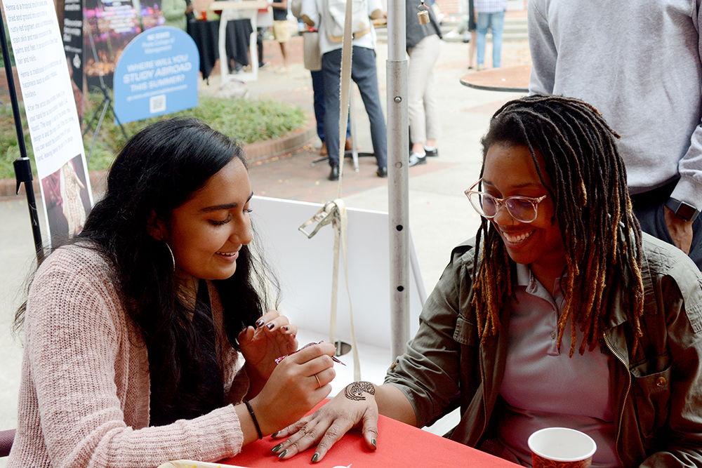 Eiman Azam, a second year majoring in business administration and statistics, draws henna on DeWhiteney Upchurch, a Raleigh local, at the Diwali festival on Tuesday, Oct. 29, 2019, at the Poole College of Management. Diwali is a Hindu festival of lights, and marks the beginning of the fiscal year in India.